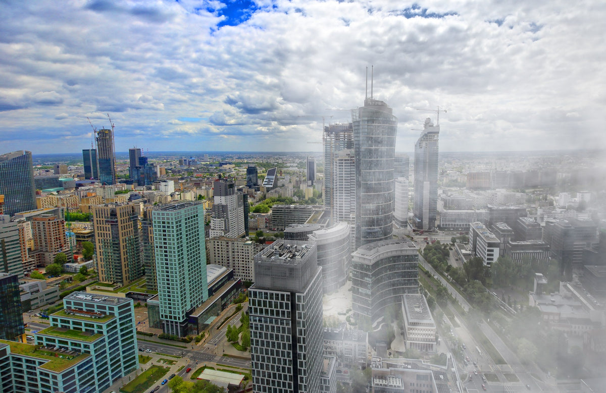 The same city skyline split in two: clear blue air on the left, grey smog on the right