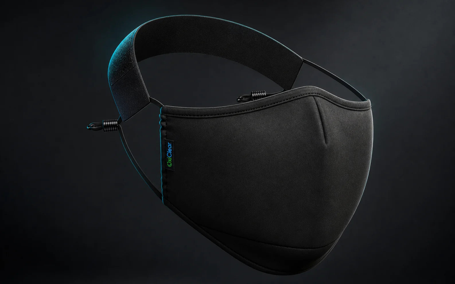 Black OxiClear N99 mask without a valve showing its smooth front, adjustable side cords, and detachable headband
